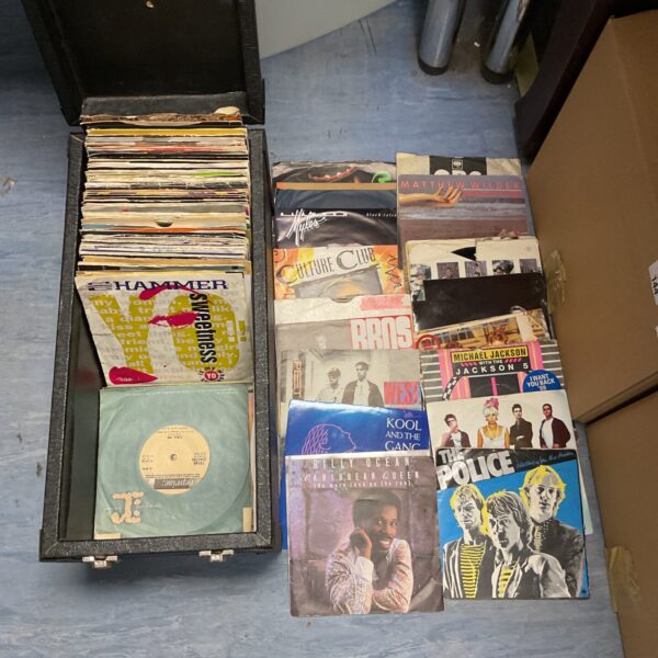 Vintage 7” vinyl single collection featuring 1980s rap and pop records.