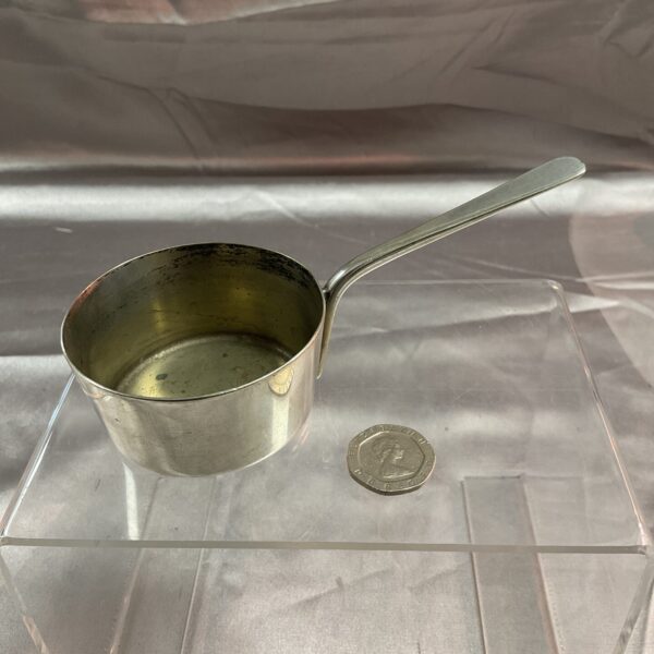 Silver plated Harrods mini saucepan ladle on display.