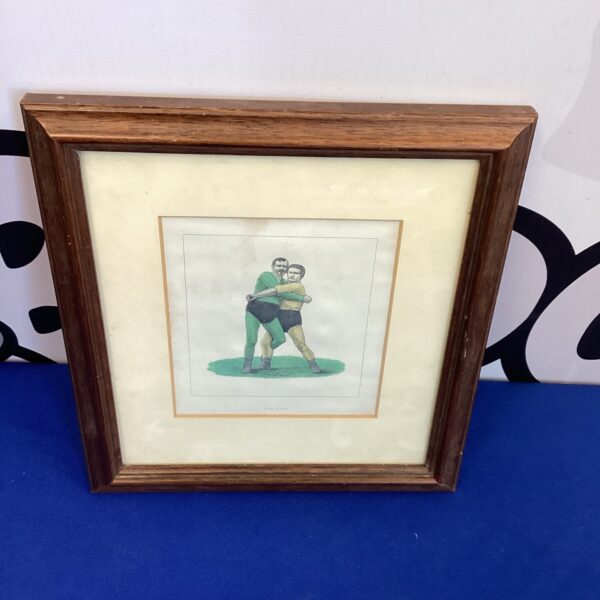 Vintage framed drawing of two wrestlers in a dynamic pose.