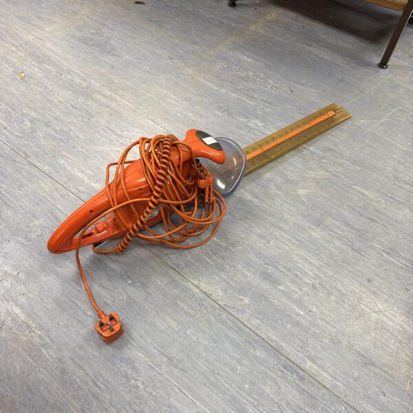 Flymo electric hedge cutter for garden hedge maintenance.