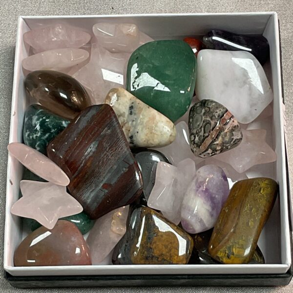 Polished crystal tray with assorted gemstones and tumbled stones.