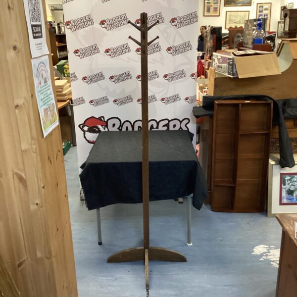 Vintage wooden coat stand with multiple hooks for coats and hats.