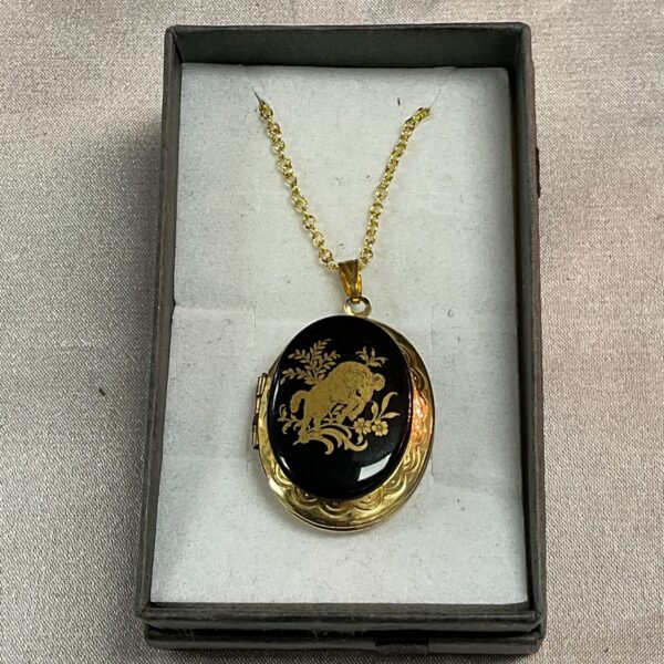 Vintage silver gilt locket necklace with floral engraving.