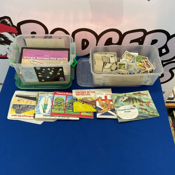 Vintage tea card collection with albums and loose cards.