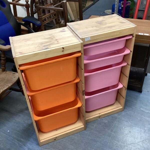 Wooden storage units with colourful plastic tubs for home organization.