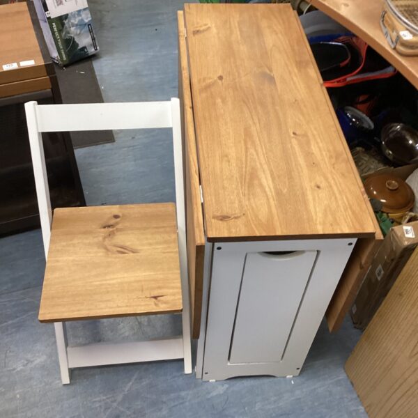 Pine drop leaf dining set with four folding chairs.