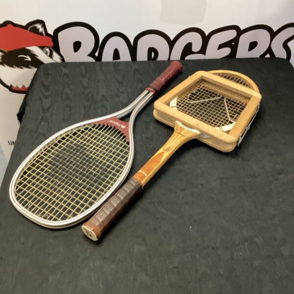 Vintage Dunlop and Jaguar tennis rackets, classic wooden construction.