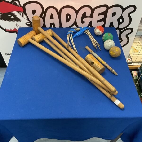 Vintage croquet set with wooden mallets and colourful balls.