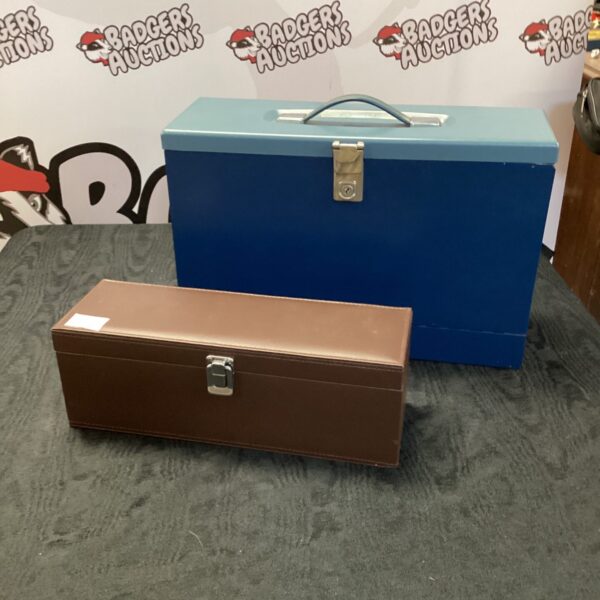 Vintage blue and brown metal filing boxes on carpet.