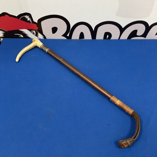 Vintage riding crop with silver knop and bone handle.