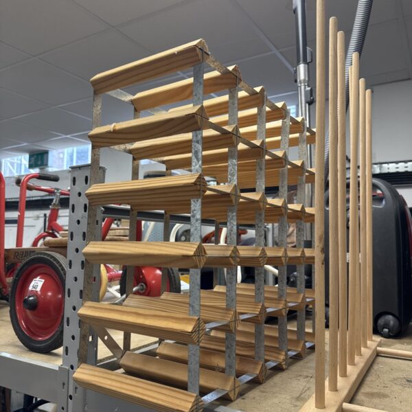 Rustic wooden and metal wine rack for bottle display.