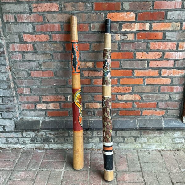 Pair of hand-painted Aboriginal didgeridoos, traditional Australian instruments.