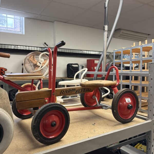 Vintage Radio Flyer hand propelled scooter with red wheels.