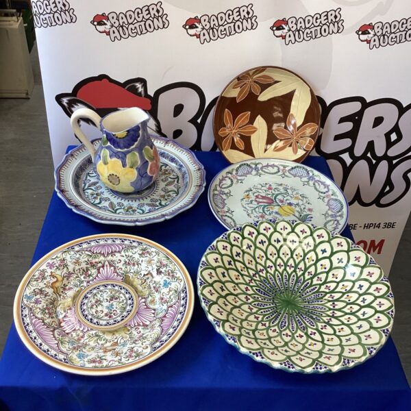 Vintage decorative plates and jug with floral design.