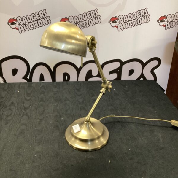 Vintage brass desk lamp with adjustable shade and arm.