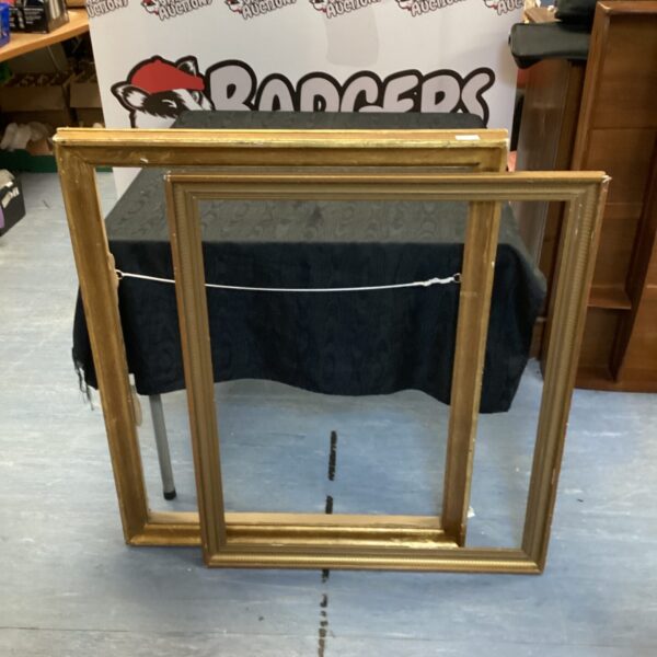 Ornate vintage wooden picture frame with gilt finish.