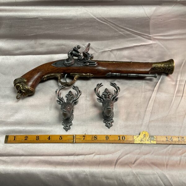 Detailed reproduction 18th-century Italian flintlock pistol for wall display.
