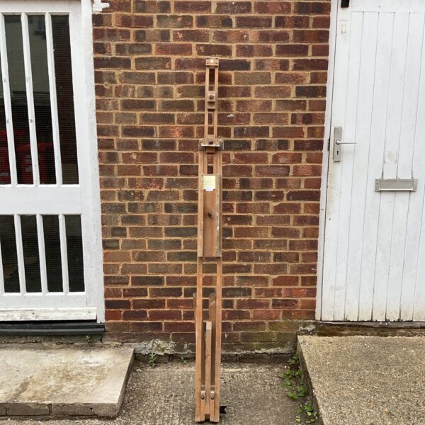 Large vintage wooden artist easel for studio painting.