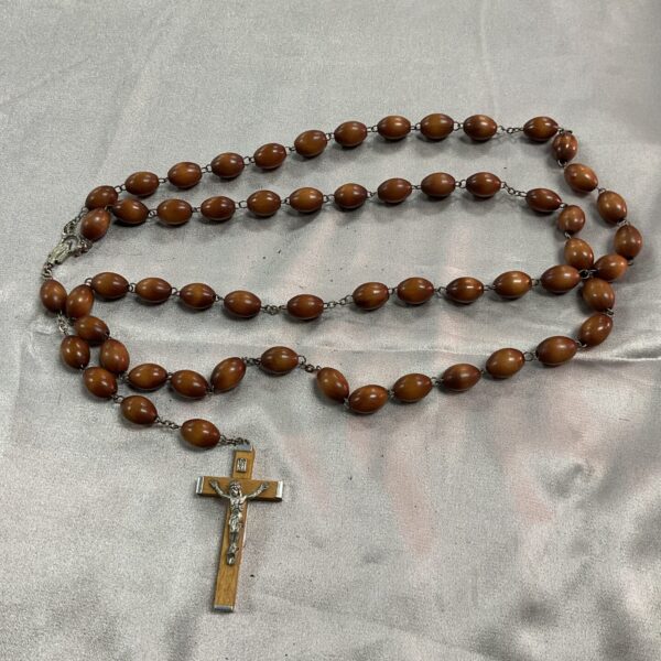 Vintage wooden rosary beads with crucifix pendant for prayer.