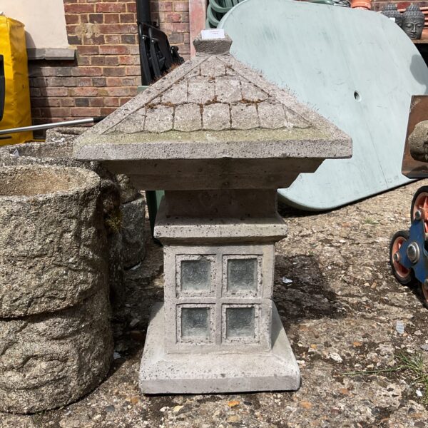 Large concrete Japanese garden lantern for outdoor lighting.