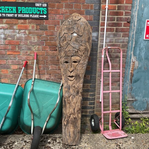 Large palm wood tiki mask with intricate carvings.