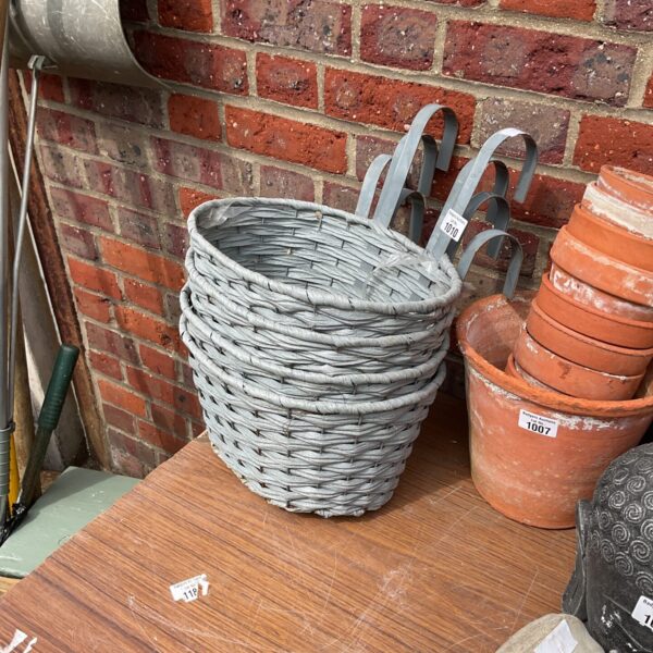 Selection of three rustic wicker hanging baskets for garden plants.