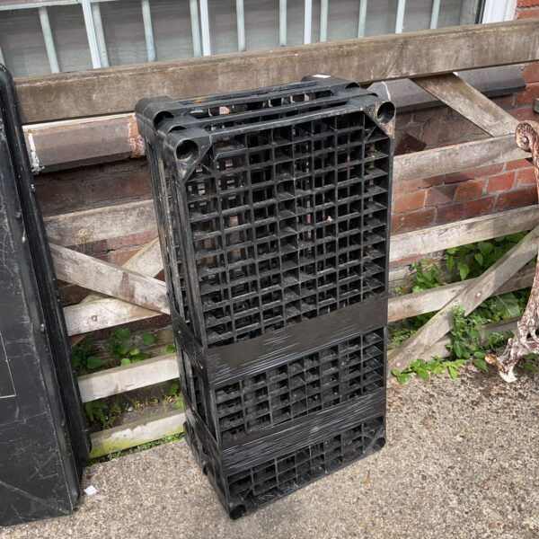 Black plastic shelving unit for garage or workshop storage.