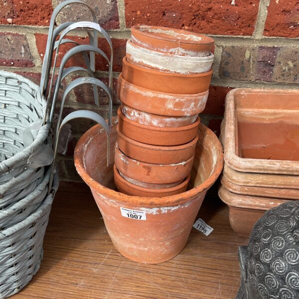 Selection of vintage terracotta pots for garden plants.