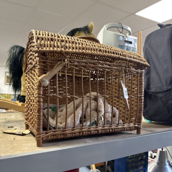 Vintage wicker pet basket with a domed top and handle.