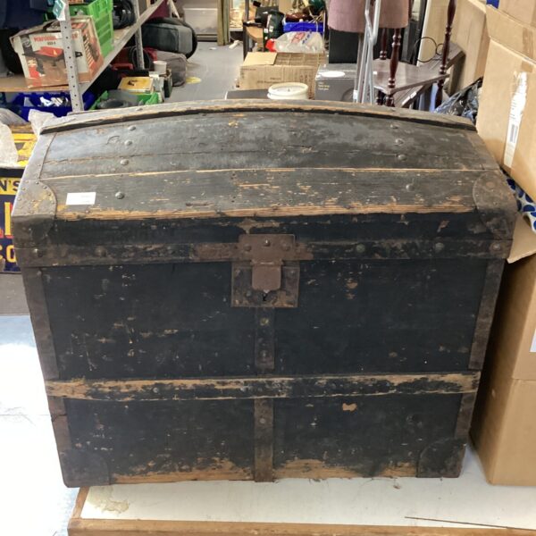 Antique domed top travel trunk, vintage luggage collectible.