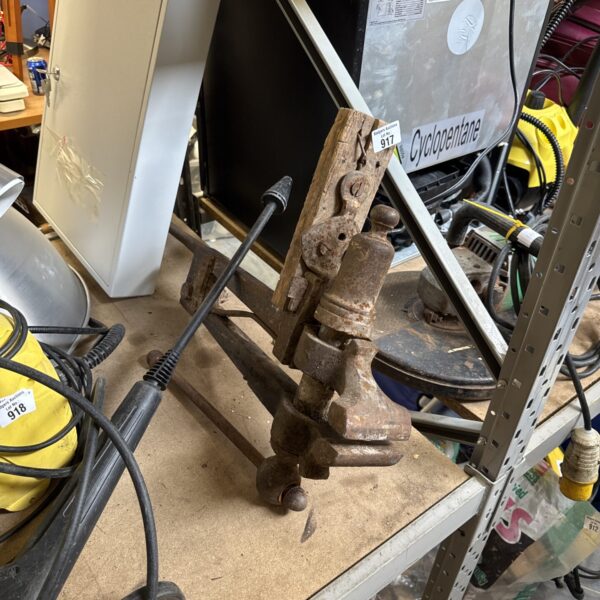 Vintage cast iron bench vice for metalworking and workshop use.