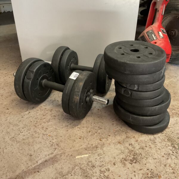 Adjustable dumbbells with cast iron weight plates for home fitness.