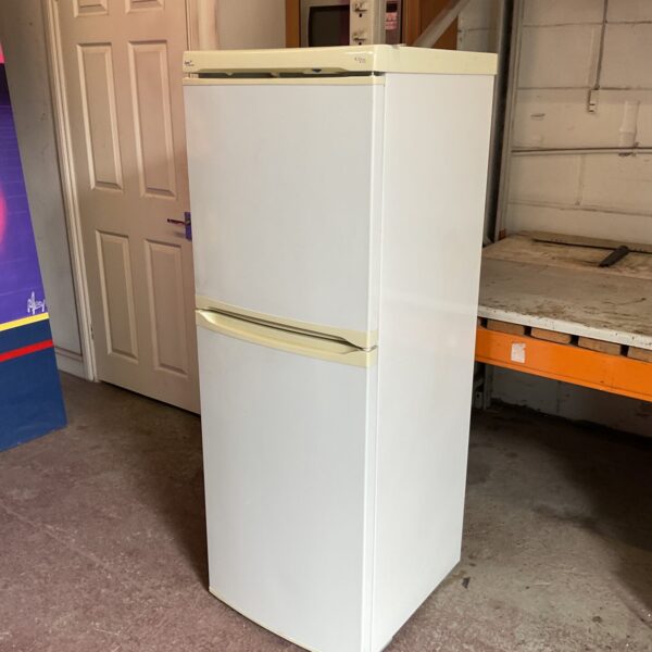 Front view of a white Lec fridge freezer in a workshop.
