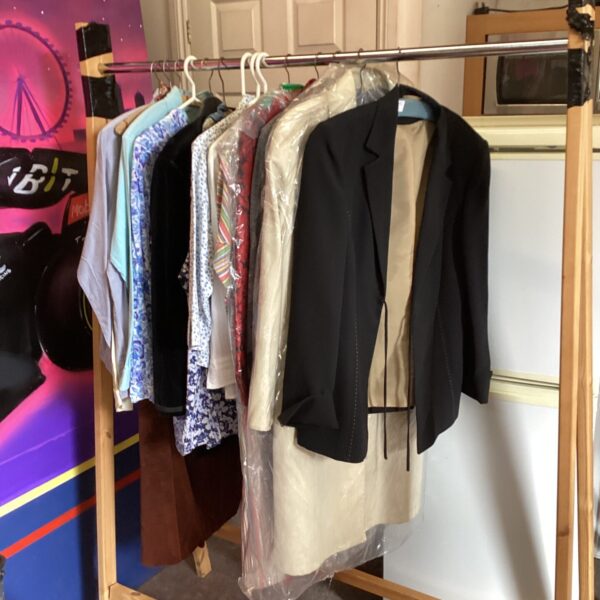 Vintage designer clothing lot featuring dresses and blouses.