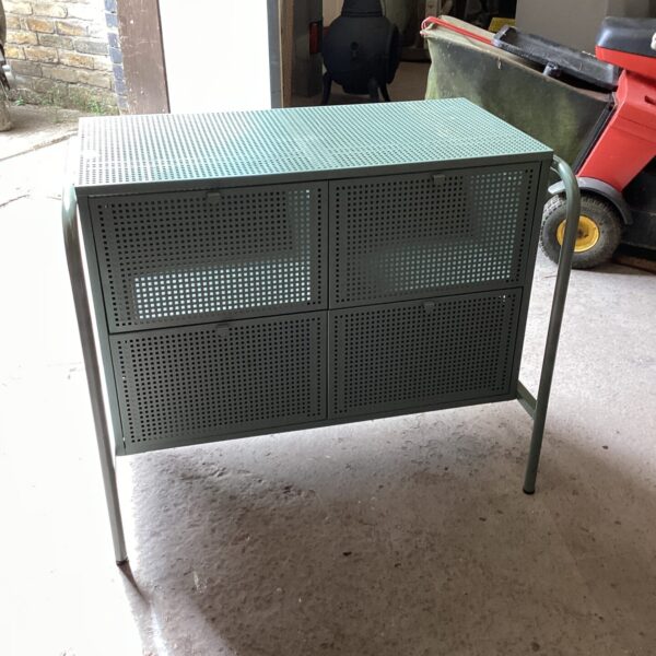 Vintage perforated metal storage cabinet with four doors.