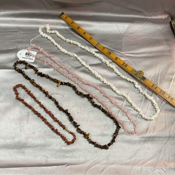 Lot of four stone crystal necklaces with varying bead colours.