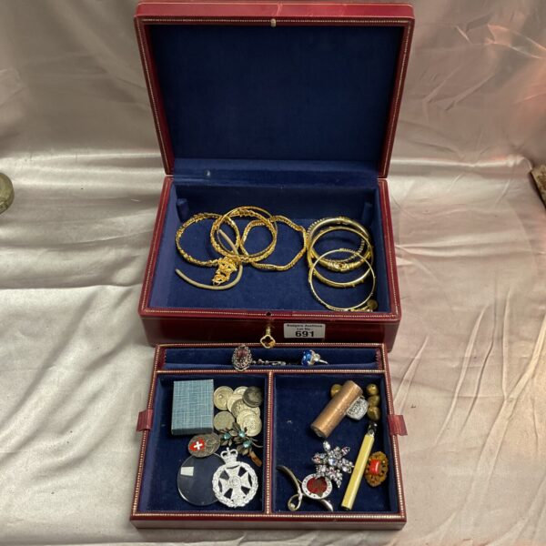 Vintage jewellery box filled with antique and costume jewellery pieces.