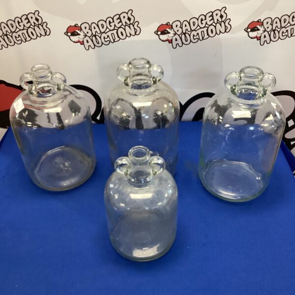 Vintage glass demijohn for liquid storage, collectible glassware.