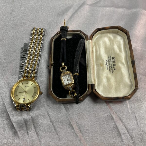 Vintage wristwatches lot featuring Orient and ladies' watch.