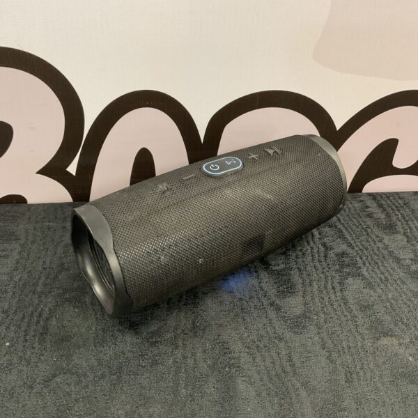 Black JBL Charge 4 portable bluetooth speaker on a dark surface.