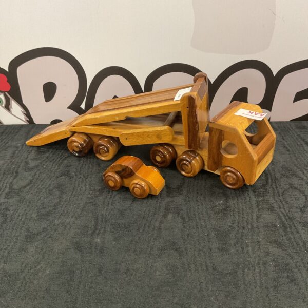 Handmade wooden car transporter toy with car.