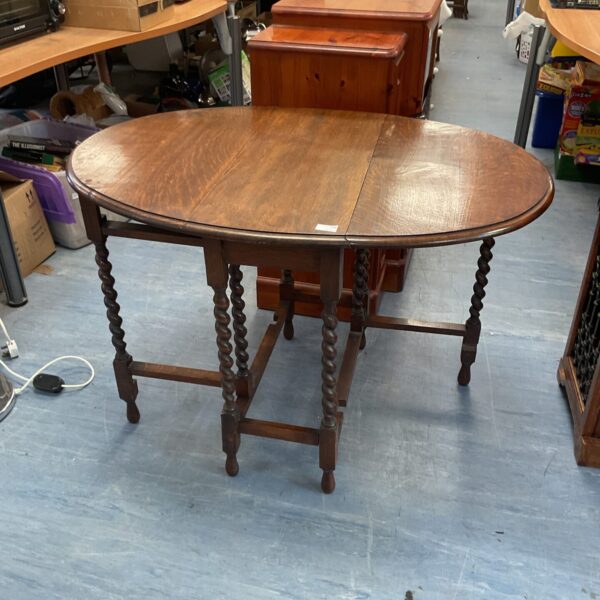 Vintage oak gate leg table with barley twist legs.