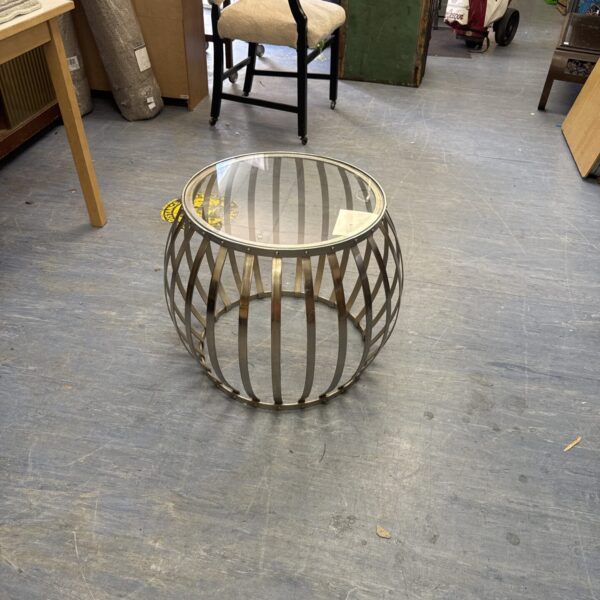 Modern stainless steel side table with glass top.
