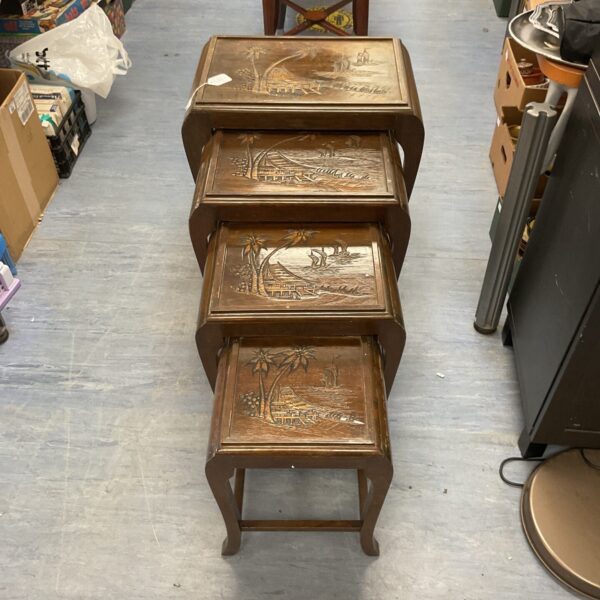 Antique oriental nesting tables set with hand-carved detailing.