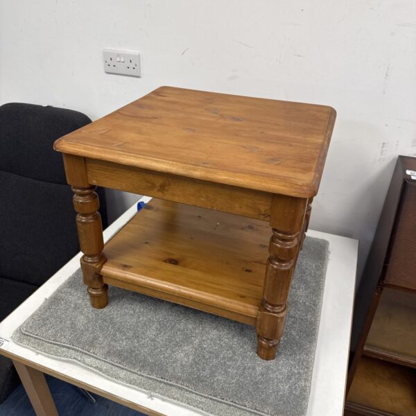 Rustic pine magazine table with turned legs.