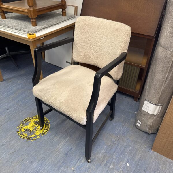 Vintage faux fur armchair on castor wheels, mid-century modern style.