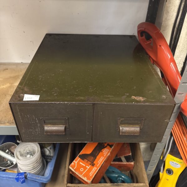 Front view of a vintage metal cabinet with two drawers.