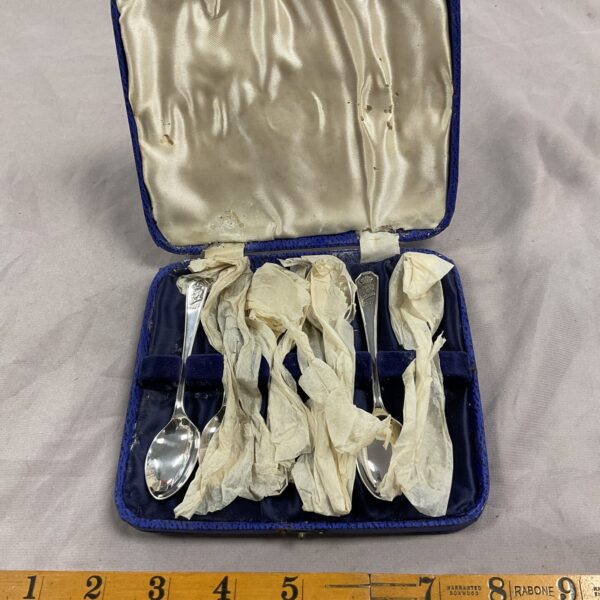 Vintage King George VI silver spoons in a velvet-lined case.