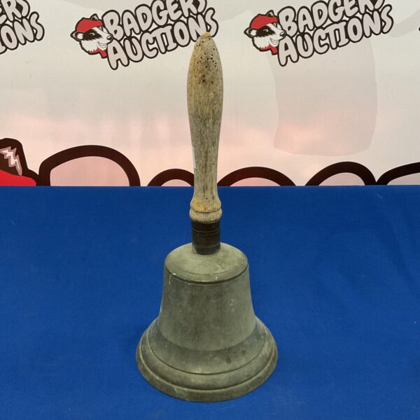 Antique bronze hand bell with a weathered patina.