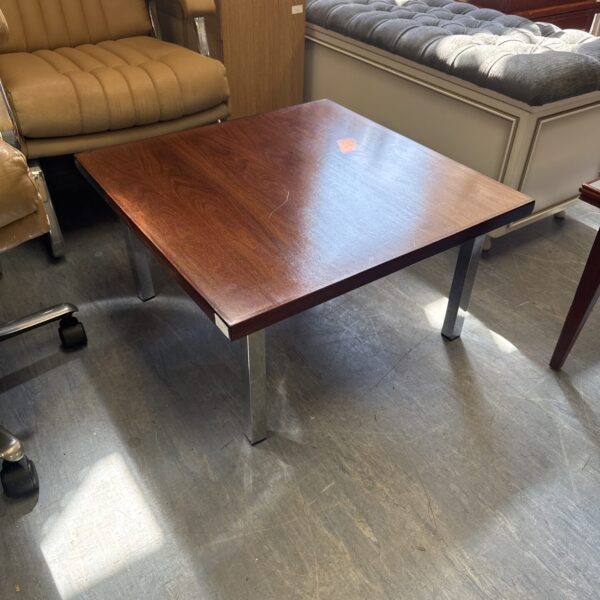 Vintage coffee table with chrome legs and wood top.